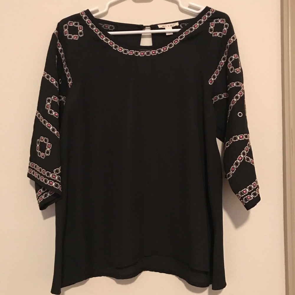 Black top with pink and white embroidered sleeves